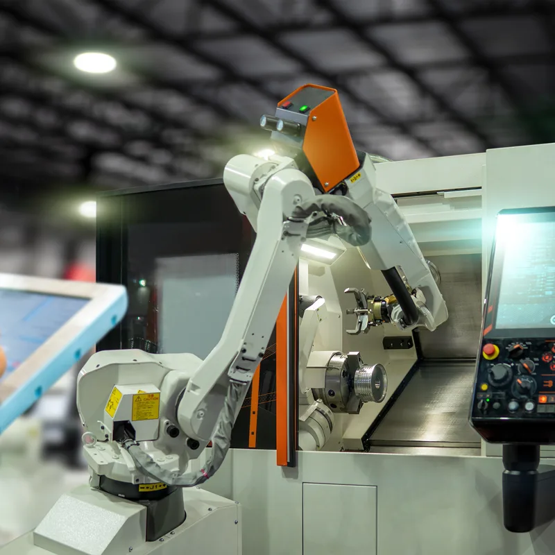 A robot arm loading a CNC machine
